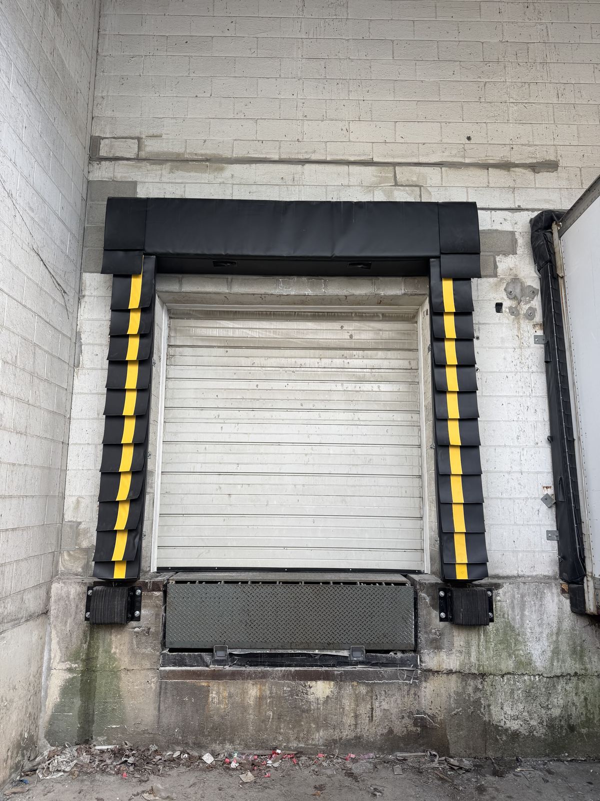 Loading dock with repaired wall and new dock door seal installed